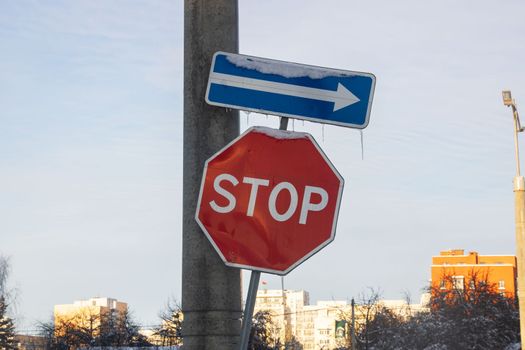 Road stop signs and post arrow closeup