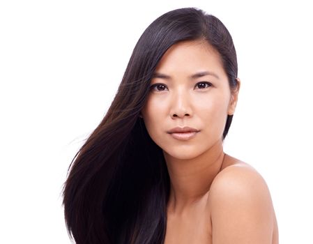 Perfect skin and hair. a beautiful young oriental woman against a white background.