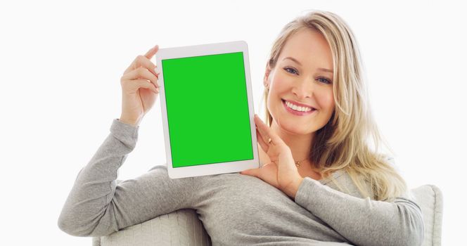This app has helped me the most. an attractive young woman holding up a tablet at home.