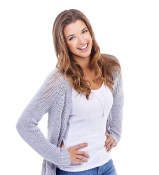 Beauty in blue jeans. A young woman in casual wear standing against a white background and smiling at the camera.