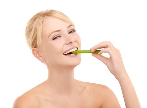 Celery - good for you. Studio shot of a young woman eating a celery stick isolated on white.