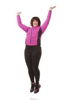 Shes positive about fitness. A portrait of an attractive plus size woman jumping while wearing sportswear.