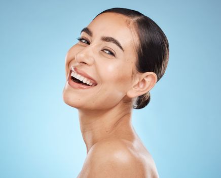 Portrait, skincare and woman with smile, cosmetics and dermatology against blue studio background. Face detox, female and lady with happiness, wellness and morning routine for grooming and treatment