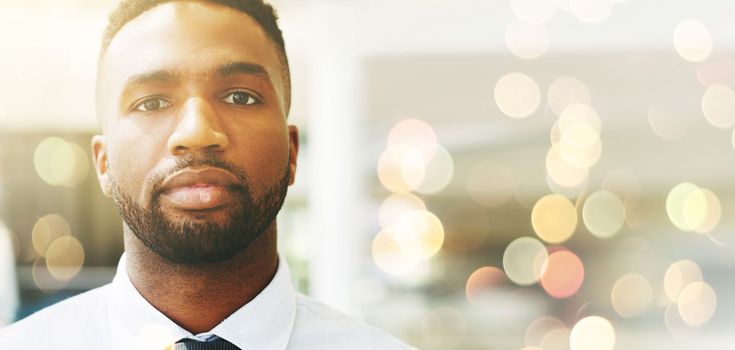 Portrait, mindset or mockup and a business black man posing with flare or overlay in the office for work. Face, vision and serious with a male employee posing on a lensflare background while working