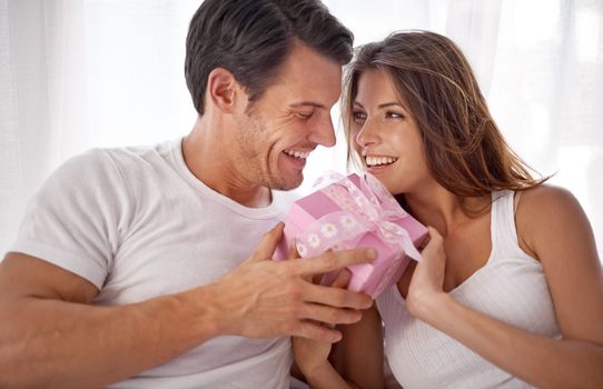 Man, woman with gift box and smile, love and happiness with partnership, relationship and celebration on Valentines day. Couple with present, luxury and commitment, gratitude and celebrate holiday