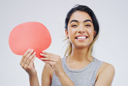 You have my full support. Portrait of an attractive young woman holding a speech bubble against a grey background.