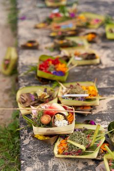 The layout on the ground of traditional offerings for the spirits on the island of Bali
