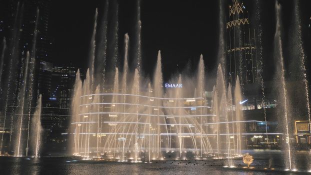 Dubai, UAE - December 14, 2019: Dancing fountains in Dubai in the evening.
