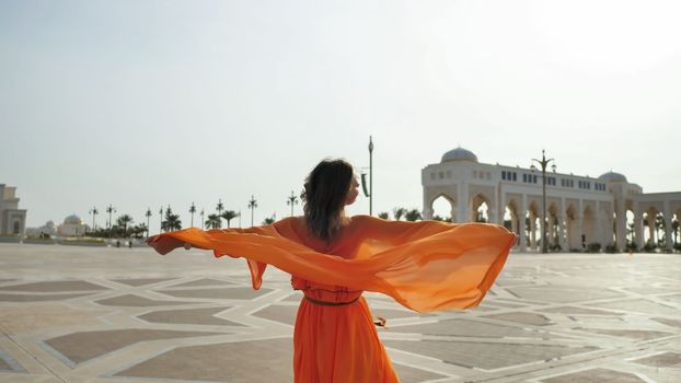 Girl posing on the background of the presidential palace in Abu Dhabi.