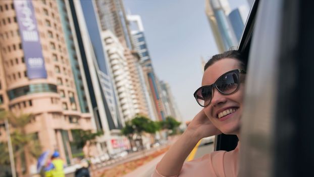Happy Girl driving a car in Dubai.