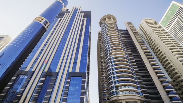 Tall and modern skyscrapers of Dubai on a sunny day.
