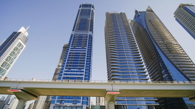 Dubai, UAE - December 14, 2019: Tall and modern skyscrapers of Dubai on a sunny day.