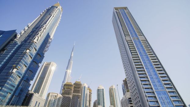 Tall and modern skyscrapers of Dubai on a sunny day.