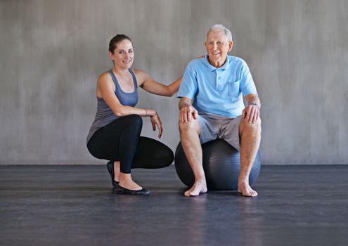 Hell be healthier in no time. a a physical therapist working with a senior man.