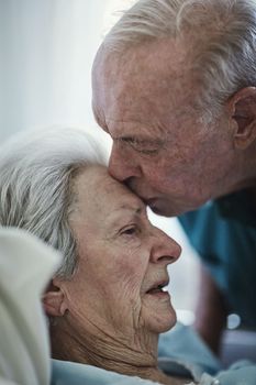 Love has no wrinkles. a senior man visiting his wife in hospital.