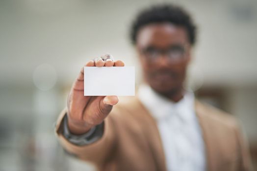 Here, have my card. an unidentifiable businessman holding up a blank businesscard.