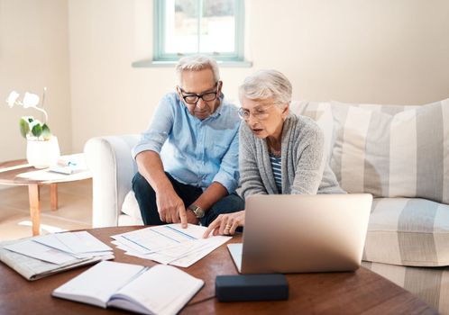 Nothing secures a future like saving. a senior couple going through paperwork at home.