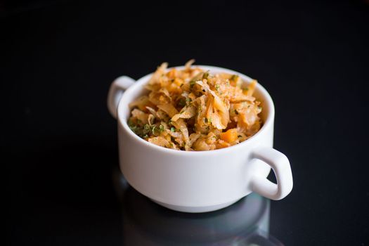 stewed cabbage with carrots and spices in a bowl