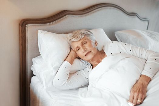 Sleep is vital for overall health. a senior woman sleeping in bed in a nursing home.