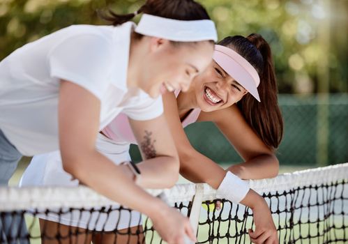 Friends, joke and laugh after a tennis game, training or workout outdoor. Women, athlete and smile outdoor on tennis court with smile, happy and funny conversation after sports practice or exercise