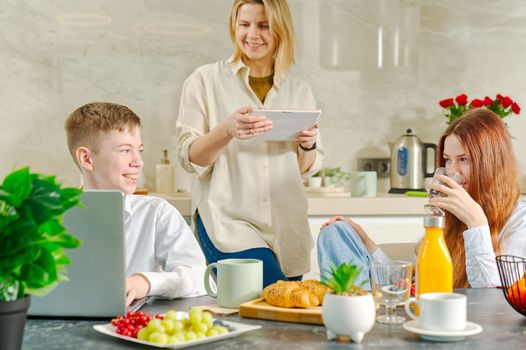 Young family with kids have fun at breakfast time. Happy family eating healthy breakfast together.