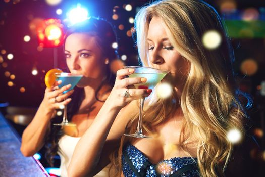 Women, cocktail and drink at party or nightclub, celebrate new year with alcohol drinks, friends and drinking together. Celebration, fun at happy hour with social and holiday event with cocktails.