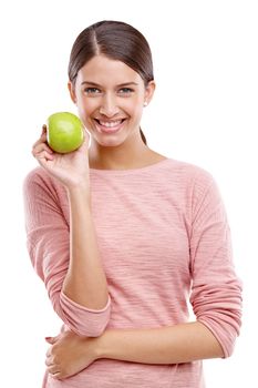 Health, apple and smile with portrait of woman for nutrition, diet and weight loss choice. Fiber, food and vitamins with isolated face of girl eating fruit for wellness, organic and natural in studio