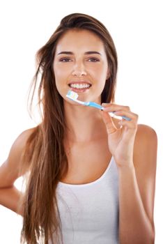 Brush them pearly whites. A gorgeous young brunette brushing her teeth in the morning.