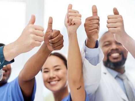 Weve got this. a group of doctors showing a thumbs up in a office.