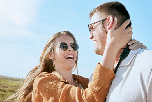 Couple, travel and hug on a vacation adventure laughing on a walk outdoor in summer. Sunglasses, smile and love of a happy couple together with a funny, happiness and fun time in nature walking