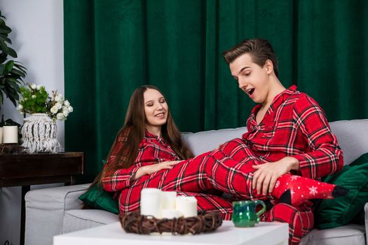 A couple in love wearing red checkered pajamas