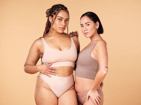 Confidence, empowerment and portrait of women in underwear isolated on a studio background. Sexy, support and models in lingerie for body positivity, comparison and acceptance on a beige backdrop