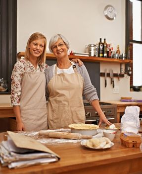 Learning grandmas secret recipes. a grandmother teaching her granddaughter how to bake.