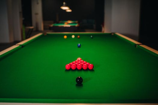 placing snooker balls on a green billiard table