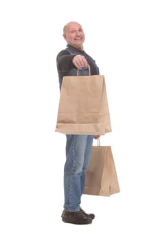 Side view of happy matured man carrying shopping bags