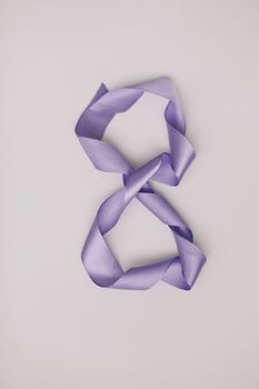 Eight made of purple ribbon. 8 March greeting card template. International Women's day background, banner, poster or brochure