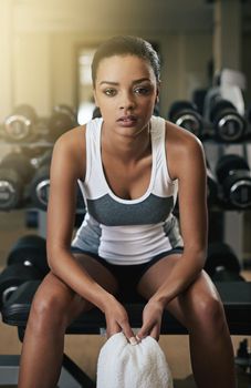 Serious about staying in shape. a young woman working out at the gym.