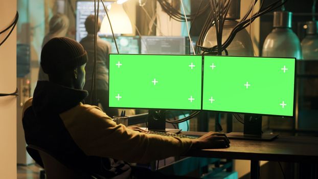 Mysterious criminal using greenscreen display to hack web network