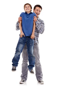 I love it when Dad does that Hes so strong. Studio shot of a father and son being playful isolated on white