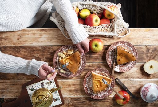 woman tasting a piece of apple pie, thanksgiving still life top view, autumn