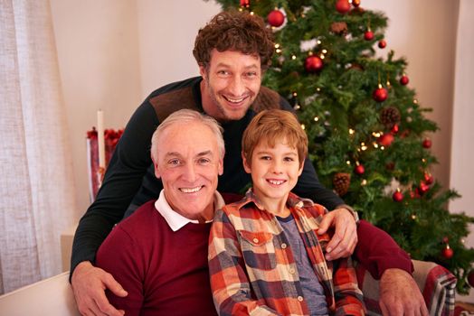 Christmas, family and holiday portrait with grandpa on home living room sofa with young kid. Smile, big family and festive vacation celebration with child, dad and grandparent in house.