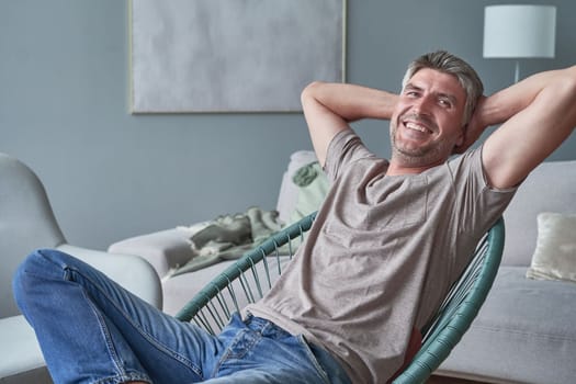 Portrait of happy successful man smiling at home