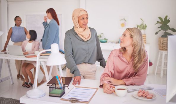 Business people, women and communication at desk in office, chatting or speaking. Thinking, meeting and ceo, leader or manager talking with employee or coworker on coffee break at company workplace
