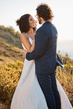 Wedding couple, interracial and hug in nature, happy and excited while celebrating love, beginning and romance. Romantic, marriage and black woman bride with groom embrace, cheerful and smile