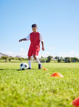 Football girl kid, grass and training for fitness, sports or balance with talent development, control or speed. Female child, fast football dribbling and exercise feet on field with strong mindset