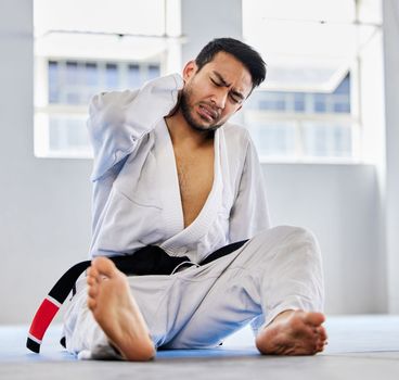 Karate, sports injury and neck pain in health gym for healthcare, medical accident and exercise training emergency. Fitness athlete, martial arts wellness and workout burnout in health club floor