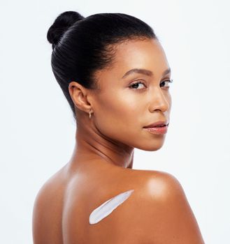 Skincare, beauty and portrait of a woman with cream for a glow isolated on a white background. Collagen, cosmetics and spa model with sunscreen, lotion or dermatology creme on a studio backdrop