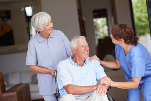 Modern care for senior needs. a nurse giving good news to her senior patient and his wife.