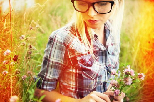 Days of whimsy. Beautiful young hipster in a field - lomo-style photography.