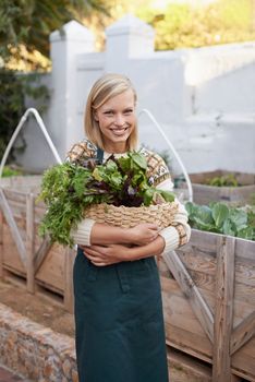 I choose only the freshest. Portrait of an attractive young woman doing some vegetable gardening.